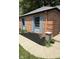 Exterior featuring a well-maintained brick home with blue shutters and manicured landscaping at 3128 W 12Th St, Anderson, IN 46011