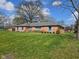 View of a brick single story home with well manicured lawn and landscaping at 3128 W 12Th St, Anderson, IN 46011