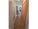 Bright hallway leading to the kitchen, showcasing vinyl flooring, closet space, and a glimpse into other areas at 3128 W 12Th St, Anderson, IN 46011