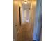 Hallway features neutral paint and carpet, doors to various rooms, and overhead lighting at 3128 W 12Th St, Anderson, IN 46011
