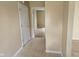 Hallway with neutral walls, tiled floor, and entry into another room at 3128 W 12Th St, Anderson, IN 46011