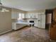 Well-lit kitchen with white cabinetry, including an eat-in bar and modern appliances, creating a functional space at 3128 W 12Th St, Anderson, IN 46011