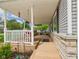Spacious covered front porch with swing and stone accents at 3140 W 18Th St, Anderson, IN 46011