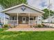 Inviting front porch with white railing, adorned with charming decorations at 3140 W 18Th St, Anderson, IN 46011