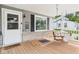 Cozy front porch features a welcoming swing and charming details at 3140 W 18Th St, Anderson, IN 46011
