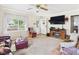 Bright living room with a faux fireplace, TV, and a large window for natural light at 3140 W 18Th St, Anderson, IN 46011