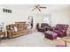 Inviting living room featuring a brown sofa, plush burgundy chairs, and carpeted floor at 3140 W 18Th St, Anderson, IN 46011