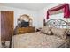 Inviting main bedroom featuring a decorative bed frame, dresser, and soft lighting at 3140 W 18Th St, Anderson, IN 46011