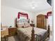 Comfortable bedroom with an elegant wrought iron bed, wood furniture, and neutral carpet at 3140 W 18Th St, Anderson, IN 46011