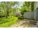 Private backyard featuring a lush lawn, mature trees, and a patio area perfect for outdoor entertaining at 3187 Valley Farms Rd, Indianapolis, IN 46214