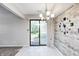 Stylish dining room features decorative light fixture, rustic wall decor, and sliding doors to the backyard at 3187 Valley Farms Rd, Indianapolis, IN 46214