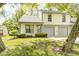 Charming two-story home with a well-maintained lawn and a two-car garage at 3187 Valley Farms Rd, Indianapolis, IN 46214