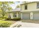 Charming two-story home featuring a well-manicured front yard and an attached two-car garage at 3187 Valley Farms Rd, Indianapolis, IN 46214