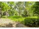 Beautifully landscaped front yard with mature trees and lush green grass at 3187 Valley Farms Rd, Indianapolis, IN 46214