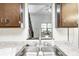 Close-up of the kitchen sink featuring granite countertops and white subway tile backsplash at 3187 Valley Farms Rd, Indianapolis, IN 46214