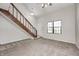 Inviting living room with wooden staircase, neutral carpet, and a large window at 3187 Valley Farms Rd, Indianapolis, IN 46214