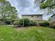 The backyard features lush greenery and a patio, providing a serene outdoor living space at 3232 St Jude Dr, Indianapolis, IN 46227