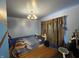 View of a bedroom with wood floors, soft lighting, and a cozy atmosphere at 3232 St Jude Dr, Indianapolis, IN 46227
