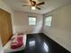 Bedroom featuring two windows, a ceiling fan, and hardwood floors at 3232 St Jude Dr, Indianapolis, IN 46227