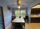 Cozy dining room featuring a ceiling fan, large window overlooking the yard, and direct access to the kitchen at , Indianapolis, IN 46227