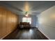 Cozy living room featuring vinyl floors, wainscotting, vintage seating and a serene view out the window at 3232 St Jude Dr, Indianapolis, IN 46227