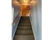 Staircase with wooden railing, neutral walls, and a traditional light fixture at 3232 St Jude Dr, Indianapolis, IN 46227