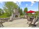 Spacious back patio with outdoor fireplace and seating area, ideal for relaxation and enjoying the outdoors at 3424 S Lookout Pass, New Palestine, IN 46163