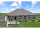 Aerial view of a well maintained backyard with lawn and patio, and an exterior view of this gorgeous home at 3424 S Lookout Pass, New Palestine, IN 46163
