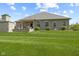 Spacious backyard, showcases a lush lawn, patio area, and stone accents, creating a perfect outdoor retreat at 3424 S Lookout Pass, New Palestine, IN 46163