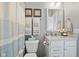 Bright bathroom featuring granite countertops, white vanity, and a striped shower curtain at 3424 S Lookout Pass, New Palestine, IN 46163