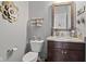 Bathroom featuring a toilet, wooden vanity, granite countertop and modern fixtures at 3424 S Lookout Pass, New Palestine, IN 46163