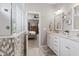 Bright bathroom featuring a double vanity with white cabinets and granite countertops and tiled walk-in shower at 3424 S Lookout Pass, New Palestine, IN 46163