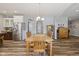 Open dining room features a wood table and chairs; kitchen with stainless appliances and a large island at 3424 S Lookout Pass, New Palestine, IN 46163
