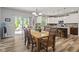 Dining room with table and chairs next to open kitchen, and sliding door to outdoor deck at 3424 S Lookout Pass, New Palestine, IN 46163