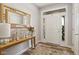 Bright entryway featuring wood floors, a decorative mirror, and a view of the front door at 3424 S Lookout Pass, New Palestine, IN 46163