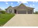 Charming home featuring a three-car garage, stone and brick facade, and well-manicured lawn at 3424 S Lookout Pass, New Palestine, IN 46163
