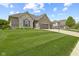 Charming home featuring a three-car garage, stone and brick facade, and well-manicured lawn at 3424 S Lookout Pass, New Palestine, IN 46163