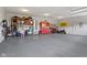 Garage with painted walls, epoxy floor, and cabinet storage provides ample space for vehicles and projects at 3424 S Lookout Pass, New Palestine, IN 46163