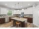 Beautiful kitchen features stainless steel appliances, granite countertops, and a large island with seating at 3424 S Lookout Pass, New Palestine, IN 46163