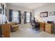 Bright home office with built-in shelving, a desk, and comfortable chair at 3424 S Lookout Pass, New Palestine, IN 46163