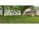 Lush backyard featuring mature trees and a well-manicured lawn, offering a serene outdoor space at 35 Meadow Dr, New Palestine, IN 46163