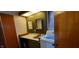 A compact bathroom features a vanity, mirror, and an adjacent washer and dryer unit at 35 Meadow Dr, New Palestine, IN 46163