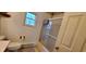 Bathroom features a shower with sliding doors, toilet, and window offering natural light at 35 Meadow Dr, New Palestine, IN 46163