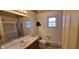 Bathroom featuring a sink with a large mirror and shower with sliding doors and natural light at 35 Meadow Dr, New Palestine, IN 46163