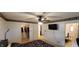 Bedroom with a ceiling fan, TV, closet, and an open doorway leading to a bathroom at 35 Meadow Dr, New Palestine, IN 46163