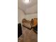 Small bedroom featuring a wooden crib with a floral patterned liner and neutral-toned walls at 35 Meadow Dr, New Palestine, IN 46163