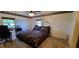 Cozy bedroom featuring a large bed, complemented by two windows and a decorative ceiling border at 35 Meadow Dr, New Palestine, IN 46163