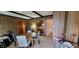 Dining room with modern grey chairs and wood paneled walls at 35 Meadow Dr, New Palestine, IN 46163