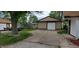 Spacious driveway leading to a detached garage, providing ample parking and storage options at 35 Meadow Dr, New Palestine, IN 46163