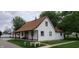 Charming home with a brown roof, white siding, a cozy front porch, and well-maintained landscaping at 35 Meadow Dr, New Palestine, IN 46163